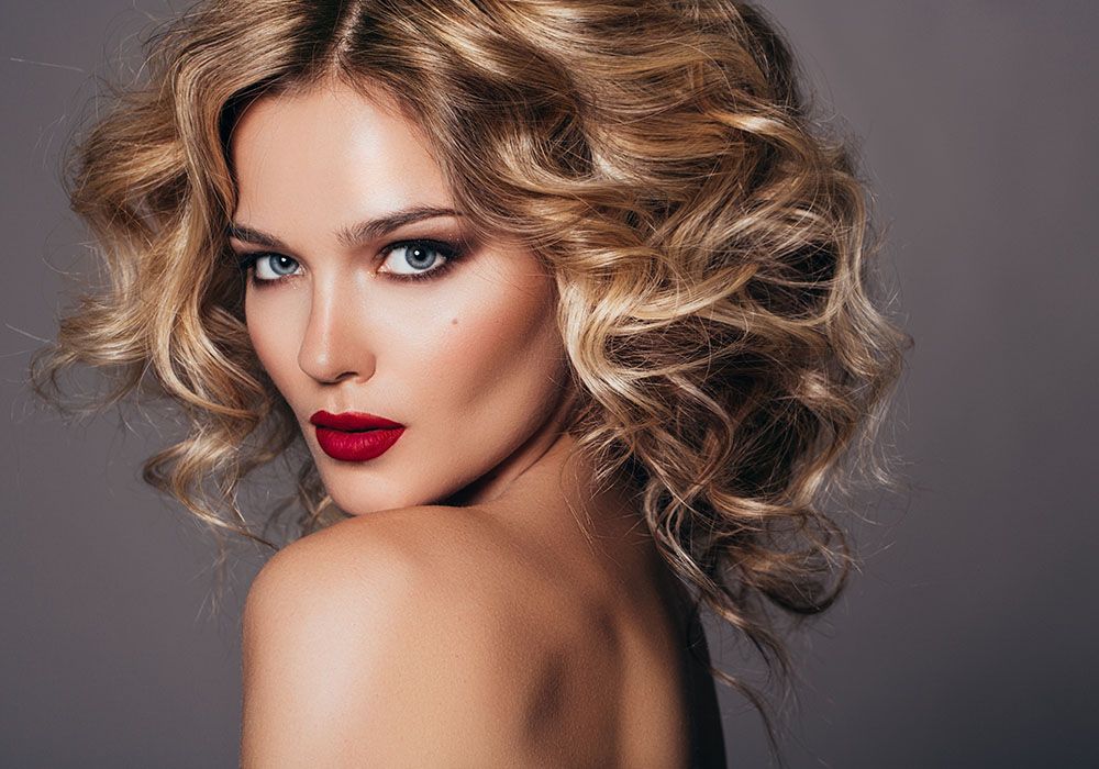 Blonde model showing how smooth the 72 hair smoothing system makes your hair